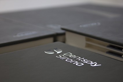 Czarny notes z metalową blaszką i tłoczonym logo